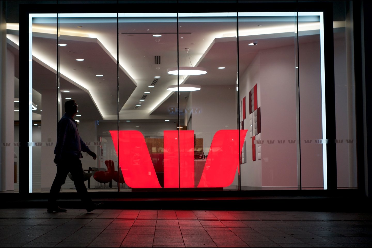 People walking around Westpac building in a busy business district