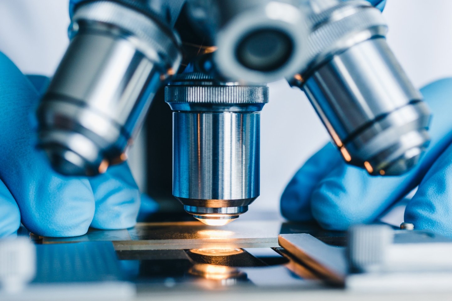 Scientist working at a microscope in a medical trial