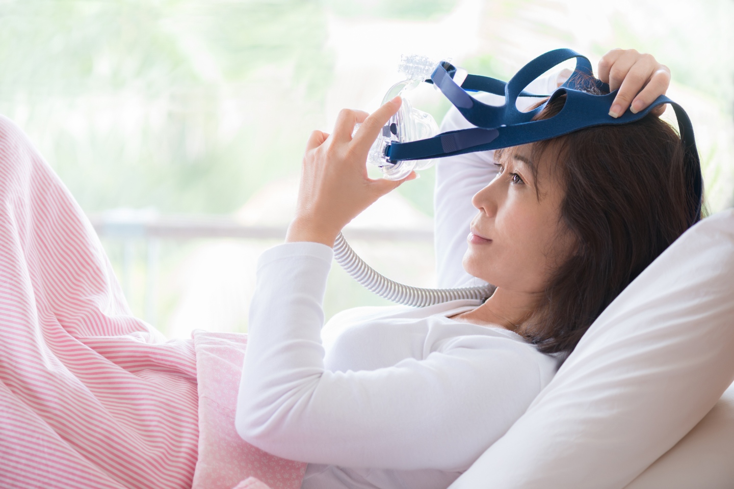 Person using a Resmed technology device to help them sleep