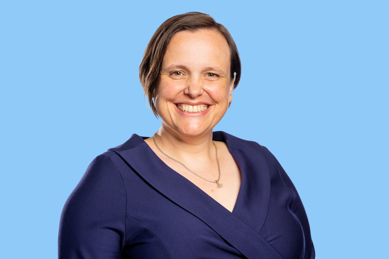Photo of Alison George, Australian Ethical Head of Ethics and Impact, with a big smile on a blue background