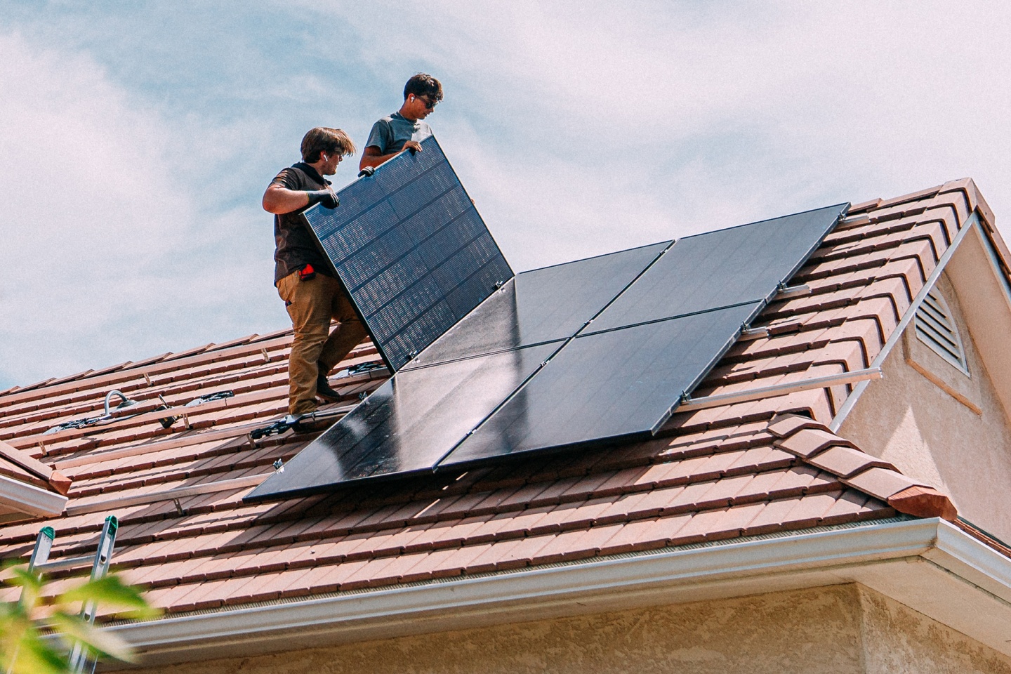 Tradesmen working installing solar panels on a house in Australia