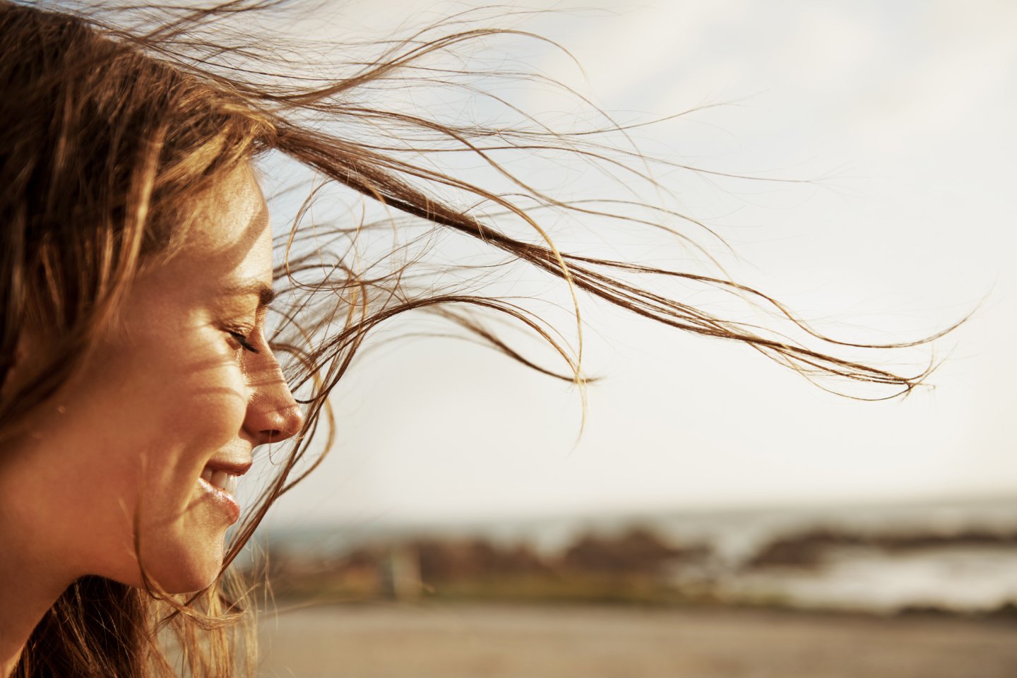 peaceful happy woman looking out at the sea